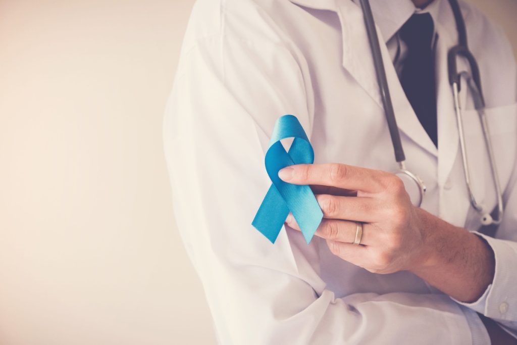 doctor hands holding light blue ribbon, prostate cancer awareness