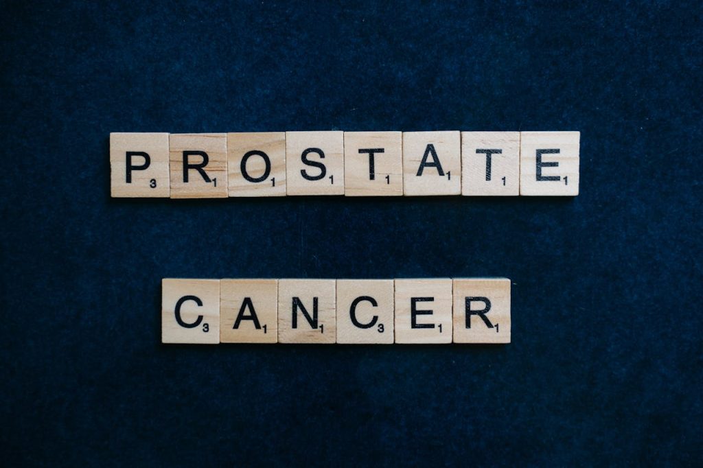 Text Prostate Cancer on tiles against a dark blue backdrop promoting awareness.